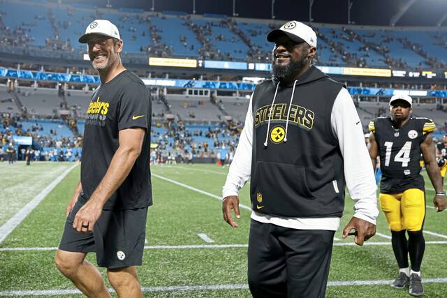 Steelers quarterback Aaron Rodgers and head coach Mike Tomlin leave the field Aug. 21 following a preseason game against the Carolina Panthers in Charlotte, N.C.