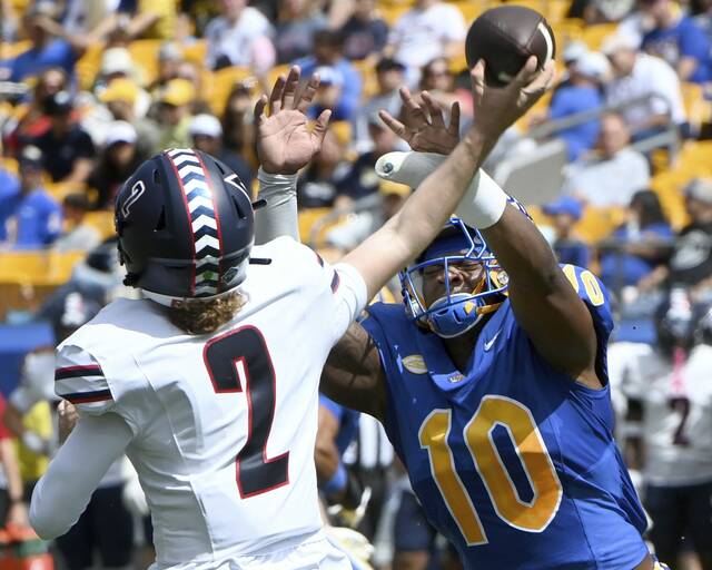 Pitt’s Blaine Spires pressures Duquesne quarterback Tyler Riddell during their game on Saturday, Aug. 30, 2025, at Acrisure Stadium.