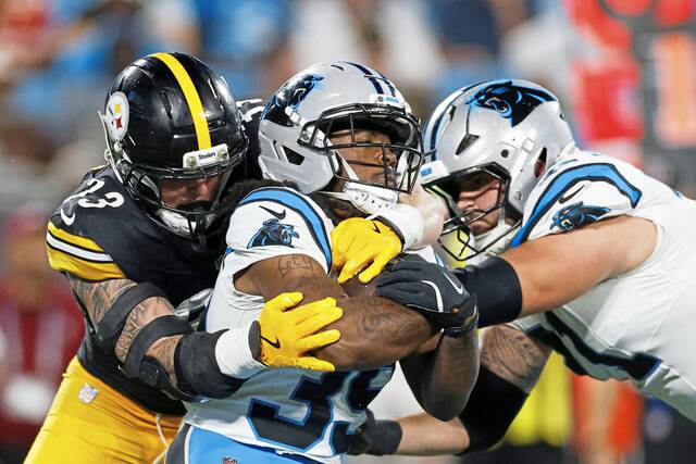 Carolina Panthers running back Emani Bailey is tackled by Pittsburgh Steelers cornerback Darius Slay during the first half of an NFL preseason football game, Thursday, Aug. 21, 2025, in Charlotte, N.C.