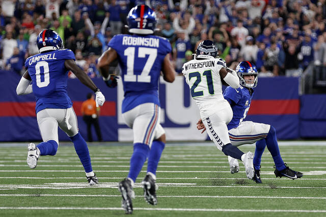 Shown while making an interception return for a touchdown during a game last season, Seattle Seahawks cornerback Devon Witherspoon is not in uniform for Sunday’s game against the Pittsburgh Steelers at Acrisure Stadium.