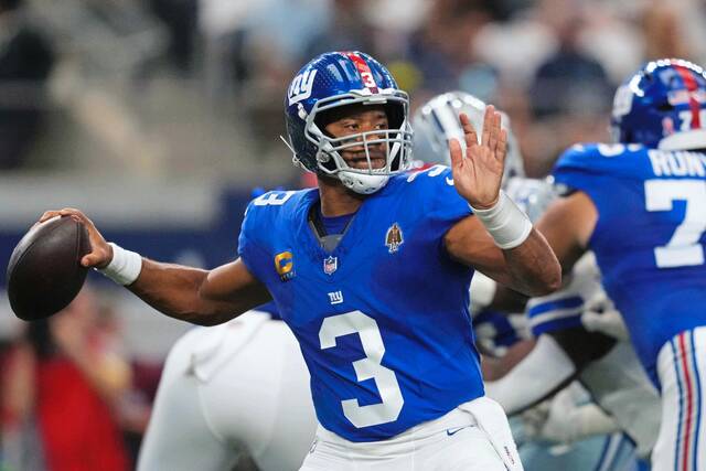 New York Giants quarterback Russell Wilson throws a pass in the first half Sunday against the Dallas Cowboys in Arlington, Texas.