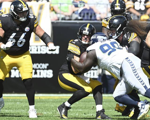 Steelers quarterback Aaron Rodgers is sacked by the Seahawks’ Jarran Reed on Sunday at Acrisure Stadium.