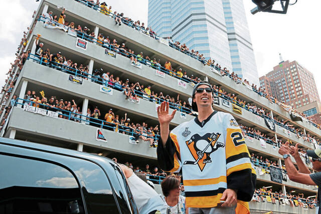 Pittsburgh Penguins goalie Marc-Andre Fleury rides in the Stanley Cup victory parade in Pittsburgh, Wednesday, June 14, 2017.