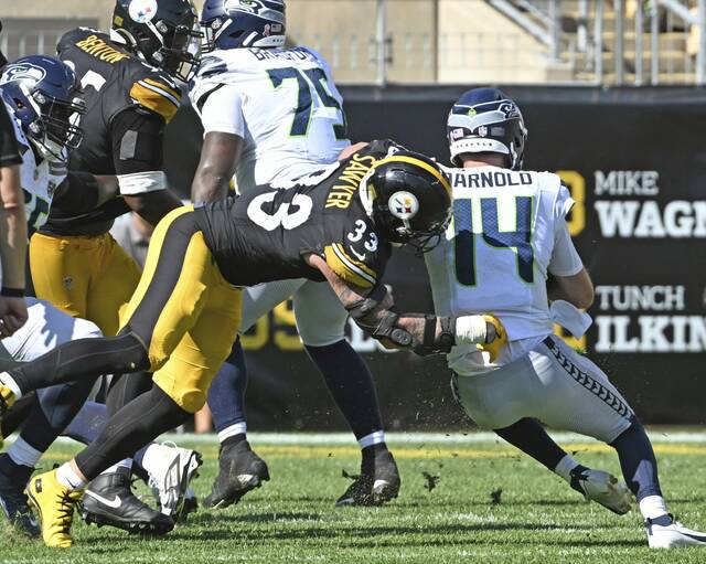Pittsburgh Steelers outside linebacker Jack Sawyer brings down Seattle Seahawks quarterback Sam Darnold for his first career sack during the fourth quarter of Sunday’s game at Acrisure Stadium.