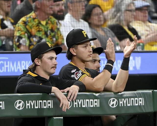 Pirates catcher Rafael Flores watches from the dugout with pitchers Bubba Chandler and Johan Oviedo during a game against the Cubs on Tuesday at PNC Park.