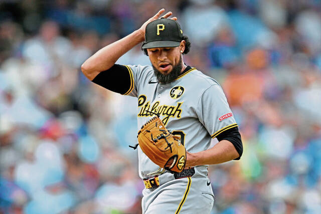Pittsburgh Pirates relief pitcher Yohan Ramirez reacts after giving up an RBI double to Chicago Cubs’ Nico Hoerner during the eighth inning of a baseball game, Saturday, Aug. 16, 2025, in Chicago.