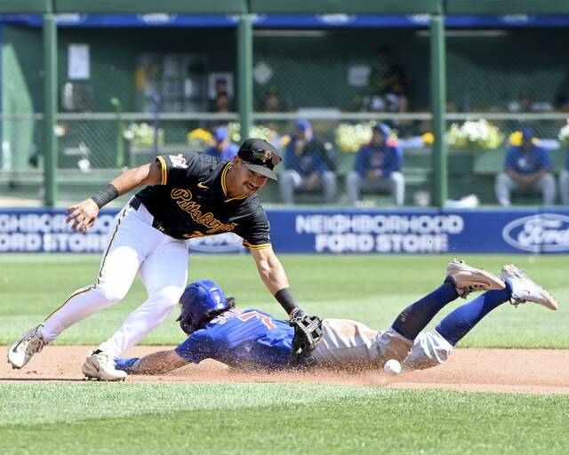 Pirates second baseman Nick Gonzales reaches for an errant throw as the Cubs’ Dansby Swanson steals second base on Wednesday, Sept. 17, 2025, at PNC Park.