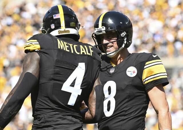 Steelers wide receiver DK Metcalf and quarterback Aaron Rodgers celebrate after a touchdown pass against Seattle on Sept. 14 at Acrisure Stadium.