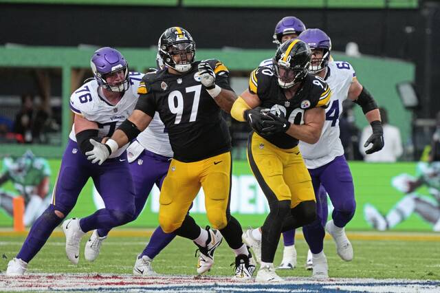 Vikings quarterback Carson Wentz (11) throws an interception to Steelers outside linebacker TJ. Watt (90) during the third quarter during an NFL International Series game Sept. 28, 2025, at Croke Park.