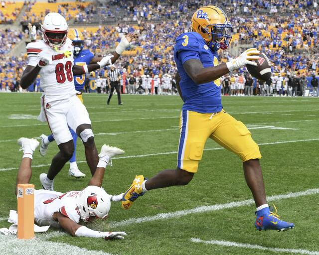Pitt’s Rasheem Biles returns an interception for a touchdown during the first quarter against Louisville on Sept. 27 at Acrisure Stadium.
