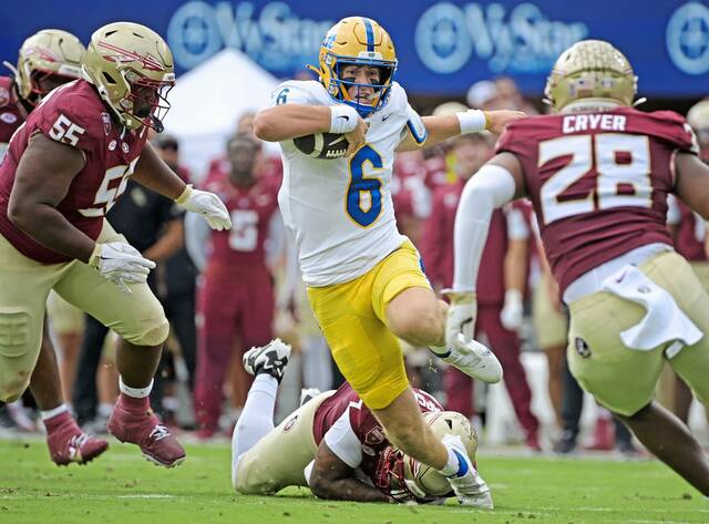Pitt quarterback Mason Heintschel (6) runs the ball in the first quarter against Florida State on Saturday.