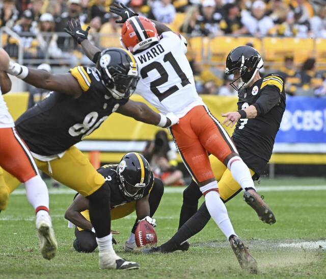 Pittsburgh Steelers kicker Chris Boswell’s plant foot slides on the rough turf as he attempts a second-half field goal during Sunday’s game against the Cleveland Browns at Acrisure Stadium. Players complained that the grass field was in poor condition.