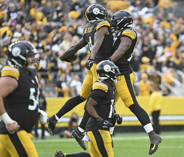 The Steelers’ Broderick Jones celebrates with DK Metcalf after Metcalf’s touchdown against the Browns on Sunday, Oct. 12, 2025 at Acrisure Stadium.