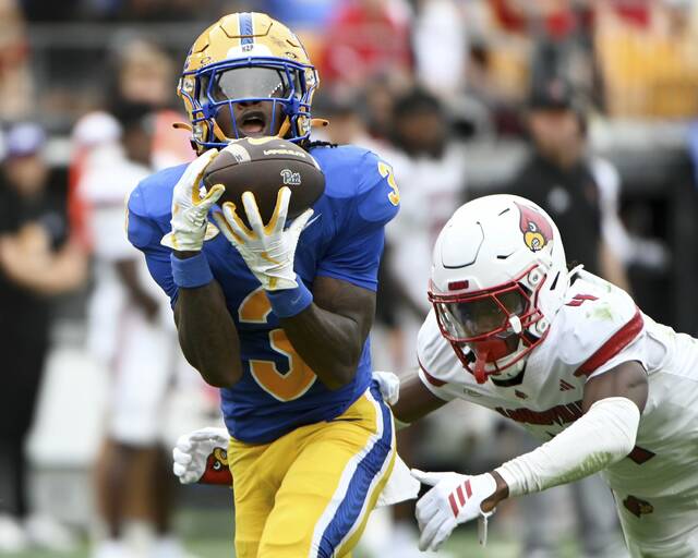 Pitt’s Blue Hicks catches a long pass, as Louisville’s Jabari Mack defends during the third quarter on Saturday, Sept. 27, 2025, at Acrisure Stadium.