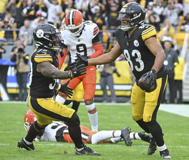 The Steelers’ Jalen Warren celebrates with Connor Heyward after Heyward’s touchdown agains the Browns on Oct. 12, 2025 at Acrisure Stadium.