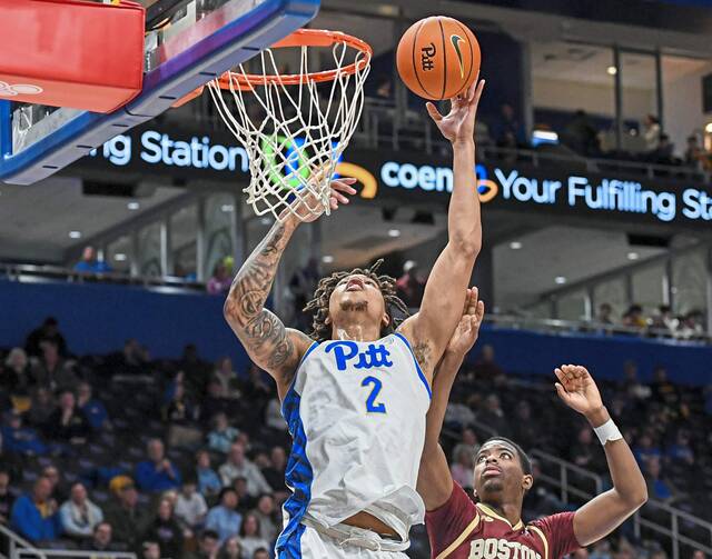 Pitt’s Cameron Corhen (2) scores on a layup over Boston College’s Chas Kelley III on Saturday, March 8, 2025, at Petersen Events Center.