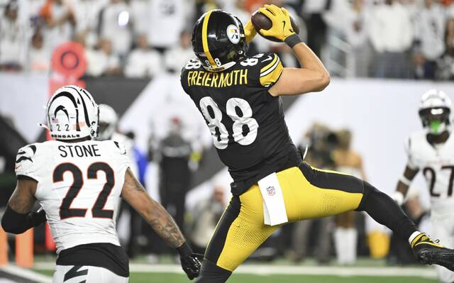Pittsburgh Steelers tight end Pat Freiermuth pulls in a third-quarter touchdown over the Cincinnati Bengals’ Geno Stone during Thursday’s game at Paycor Stadium.