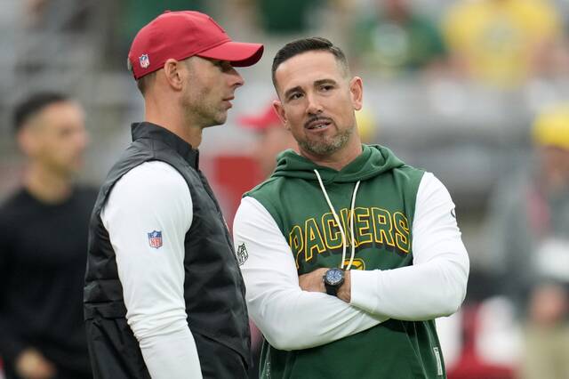 Arizona Cardinals head coach Jonathan Gannon talks to Green Bay Packers head coach Matt Lafleur before a game in Glendale, Ariz.