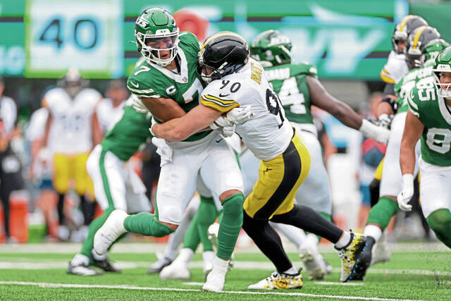 Jets quarterback Justin Fields is hit by Steelers linebacker T.J. Watt in the first half of their Sept. 7 game in East Rutherford, N.J.