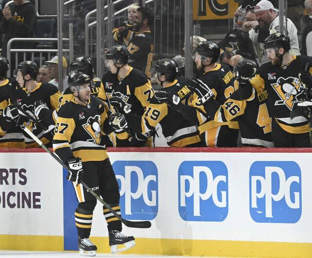 The Penguins’ Sidney Crosby celebrates with the bench after his goal against the Canucks in the second period Tuesday Oct. 21, 2025 at PPG Paints Arena.