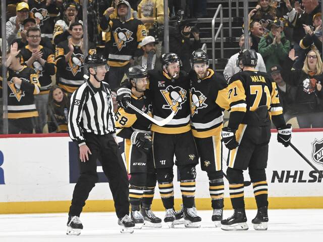 The Penguins celebrate a goal against the Vancouver Canucks during the second period of a 5-1 win at PPG Paints Arena on Tuesday.
