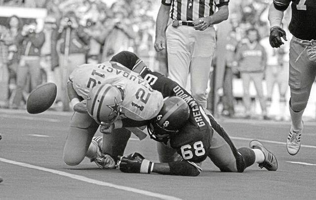 In this Oct. 28, 1979, file photo, the ball pops loose as Dallas quarterback Roger Staubach is tackled by Pittsburgh Steelers’ L.C. Greenwood. Greenwood on Thursday advanced a round in the consideration for Hall of Fame induction into the 2026 class.