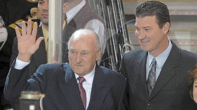 Eddie Johnston is honored for his 25 years with the Penguins by then-owner Mario Lemieux before a game against Boston on March 15, 2009, at Mellon Arena.