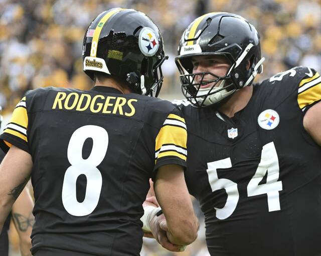 Pittsburgh Steelers center Zach Frazier celebrates with quarterback Aaron Rodgers after a Rodgers touchdown during the Oct. 12 win against the Cleveland Browns at Acrisure Stadium. Frazier missed some practice time this week because of a calf injury.