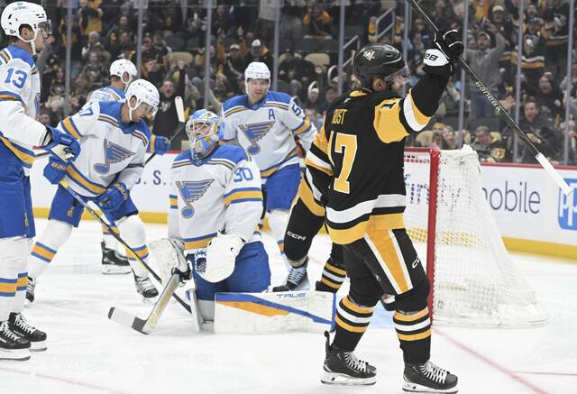 The Penguins’ Bryan Rust celebrates his goal against the Blues in the first period Monday at PPG Paints Arena.