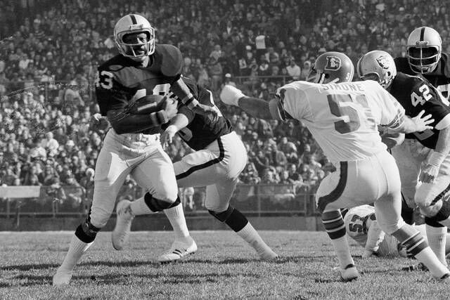 George Atkinson of the Oakland Raiders breaks inside Mike Simone of the Denver Broncos as he returns a Broncos punt 32 yards in Oakland, Calif., on Dec. 16, 1973.