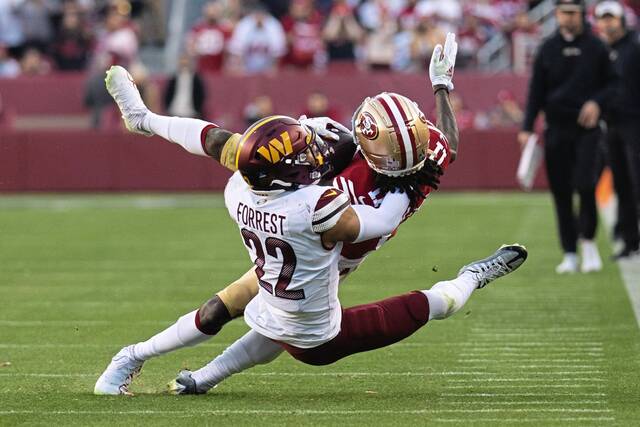 Washington Commanders safety Darrick Forrest tackles San Francisco 49ers wide receiver Brandon Aiyuk in a Dec 24, 2022, game at Levi’s Stadium in Santa Clara, Calif.