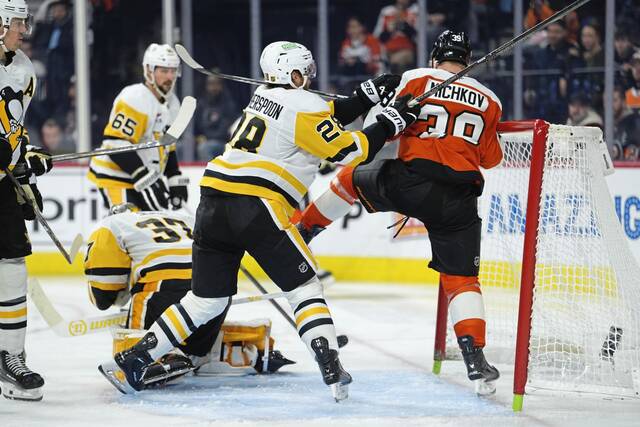 Penguins defenseman Parker Wotherspoon hits Flyers right winger Matvei Michkov in the third period at Xfinity Mobile Arena in Philadelphia.