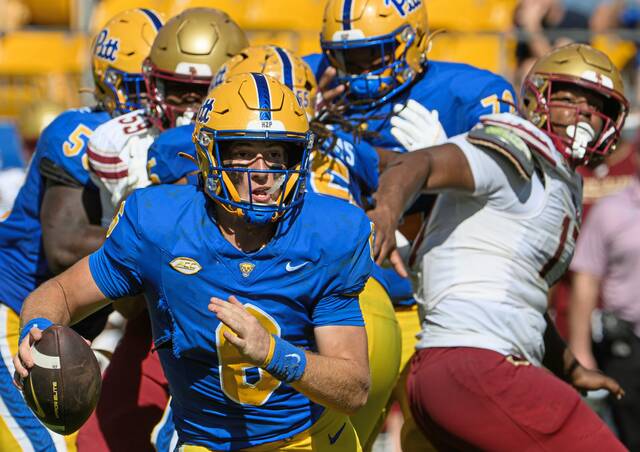 Pitt freshman quarterback Mason Heintschel evades pressure from Boston College on Saturday, Oct. 4, 2025, at Acrisure Stadium.