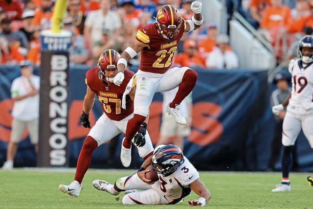 During a 2023 game in Denver, Washington Commanders safety Darrick Forrest leaps over Denver Broncos quarterback Russell Wilson. Forrest joined the Steelers practice squad Wednesday.