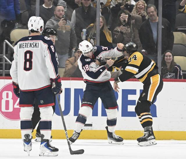 The Penguins’ Mathew Dumba and the Blue Jackets’ Boone Jenner fight in the first period Oct. 25, 2025 at PPG Paints Arena.