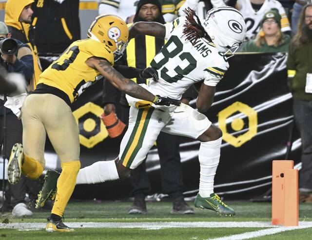 Pittsburgh Steelers cornerback Darius Slay (left) cannot make the tackle on Green Packers receiver Savion Williams as he gets into the end zone for a third-quarter touchdown Sunday at Acrisure Stadium. Slay missed Thursday’s practice because of a personal matter.