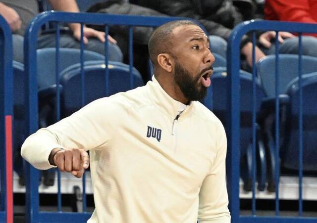 Duquesne head coach Dru Joyce III talks to his team against St. Joseph’s on Jan. 8 at UPMC Cooper Fieldhouse.