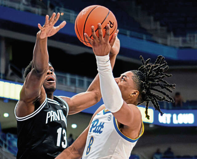 Pitt guard Omari Witherspoon (8) attempts a shot over Providence’s Cole Hargrove on Oct. 19, 2025, at Petersen Events Center.