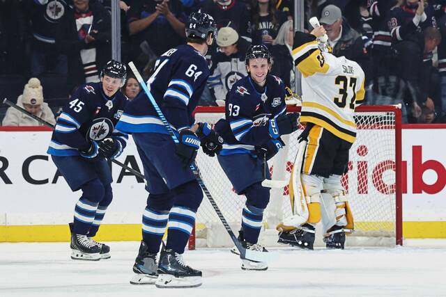 Jets center Brad Lambert (93) reacts after scoring against the Penguins in the first period Saturday.