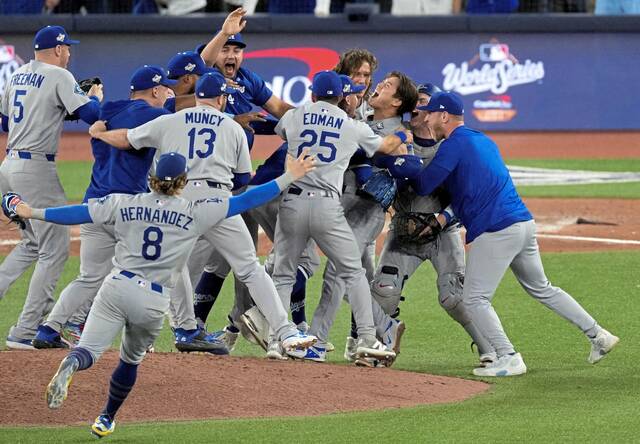 Los Angeles Dodgers pitcher Yoshinobu Yamamoto (18) celebrates with teammates after defeating the Toronto Blue Jays in Game 7 of the 2025 MLB World Series on Nov. 1, 2025, at Rogers Centre.