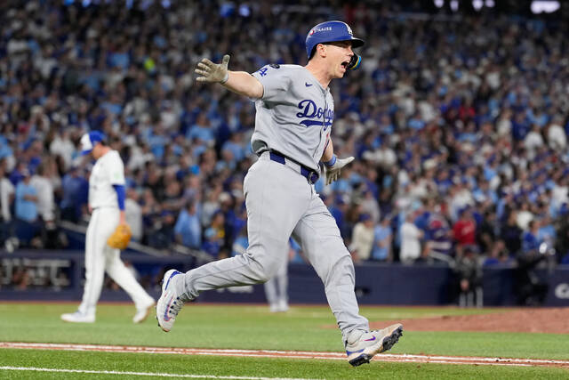 Los Angeles Dodgers’ Will Smith celebrates a home run against the Toronto Blue Jays during the 11th inning in Game 7 of the World Series in Toronto.