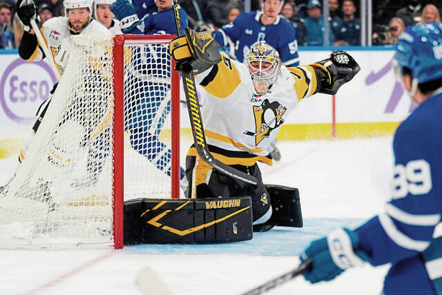 Penguins goaltender Tristan Jarry makes a save on Toronto forward Nic Robertson during the first period Monday.