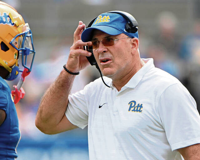 Pitt head coach Pat Narduzzi talks with Kyle Louis on the sideline during the Panthers’ game against Louisville on Sept. 27, 2025, at Acrisure Stadium.