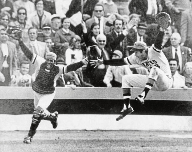 Pittsburgh Pirates catcher Manny Sanguillen, left, and pitcher Steve Blass celebrate as Blass completes Game 7 for a 2-1 win to claim the World Series title on Oct. 17, 1971, at Memorial Stadium in Baltimore.