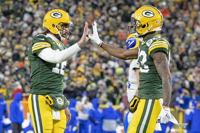 Packers quarterback Aaron Rodgers (left) and receiver Marquez Valdes-Scantling react to a touchdown during a 2021 game.