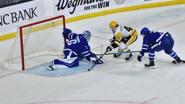 Wilkes-Barre/Scranton Penguins forward Rafael Harvey-Pinard shoots against Toronto Marlies goaltender Artur Akhtyamov as Marlies defenseman Henry Thrun applies pressure during a game at Mohegan Arena in Wilkes-Barre on Wednesday. The Marlies won, 4-3, in overtime.
