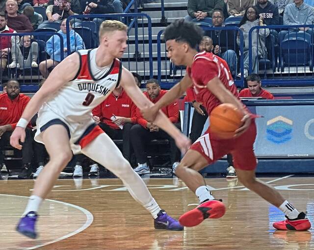 Duquesne's Jakub Necas defends against Sacred Heart's Nyle Ralph-Beyer, Friday, Nov. 7, 2025, at UPMC Cooper Fieldhouse.