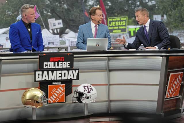 From left: Pat Mcafee, Nick Saban and Kirk Herbstreit talk on the set of ESPN’s “College Gameday” in August 2024 in College Station, Texas.