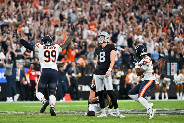 Chicago Bears cornerback Josh Blackwell (No. 39) and defensive tackle Gervon Dexter Sr. (No. 99) celebrate after Blackwell blocked a field goal by Las Vegas Raiders kicker Daniel Carlson during a September game. The Bears will be without all three starting linebackers for Sunday’s home game against the Pittsburgh Steelers.