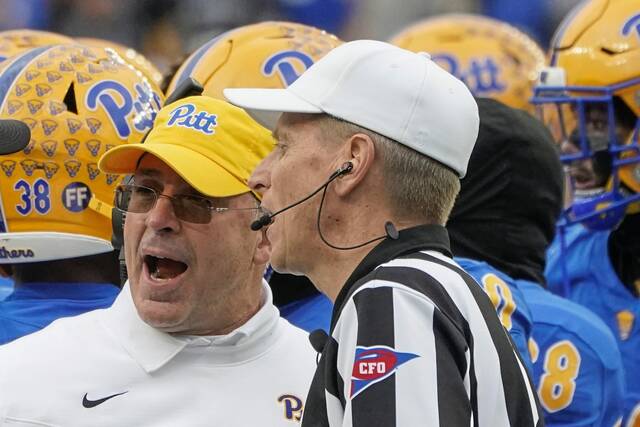 Pitt coach Pat Narduzzi, left, talks with referee Jeff Heaser after the Pitt defense appeared down Miami running back Jaylan Knighton (4) for a safety in the second half of an NCAA college football game, Saturday, Oct. 30, 2021, in Pittsburgh.